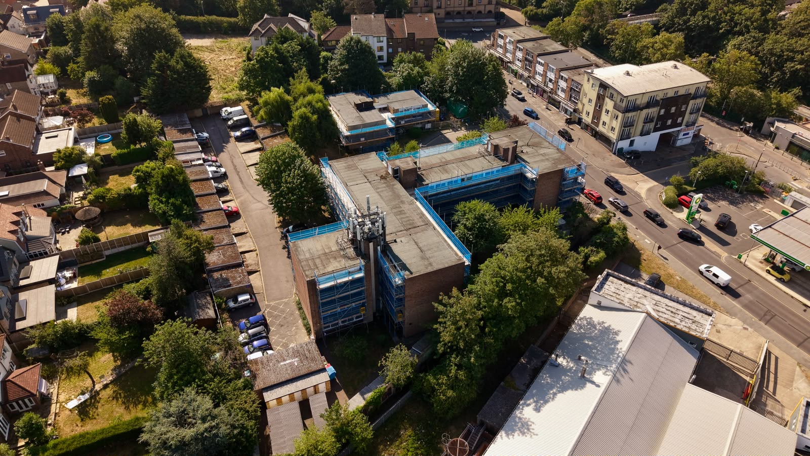 Drone view of a phased scaffold across two residential blocks on a main road