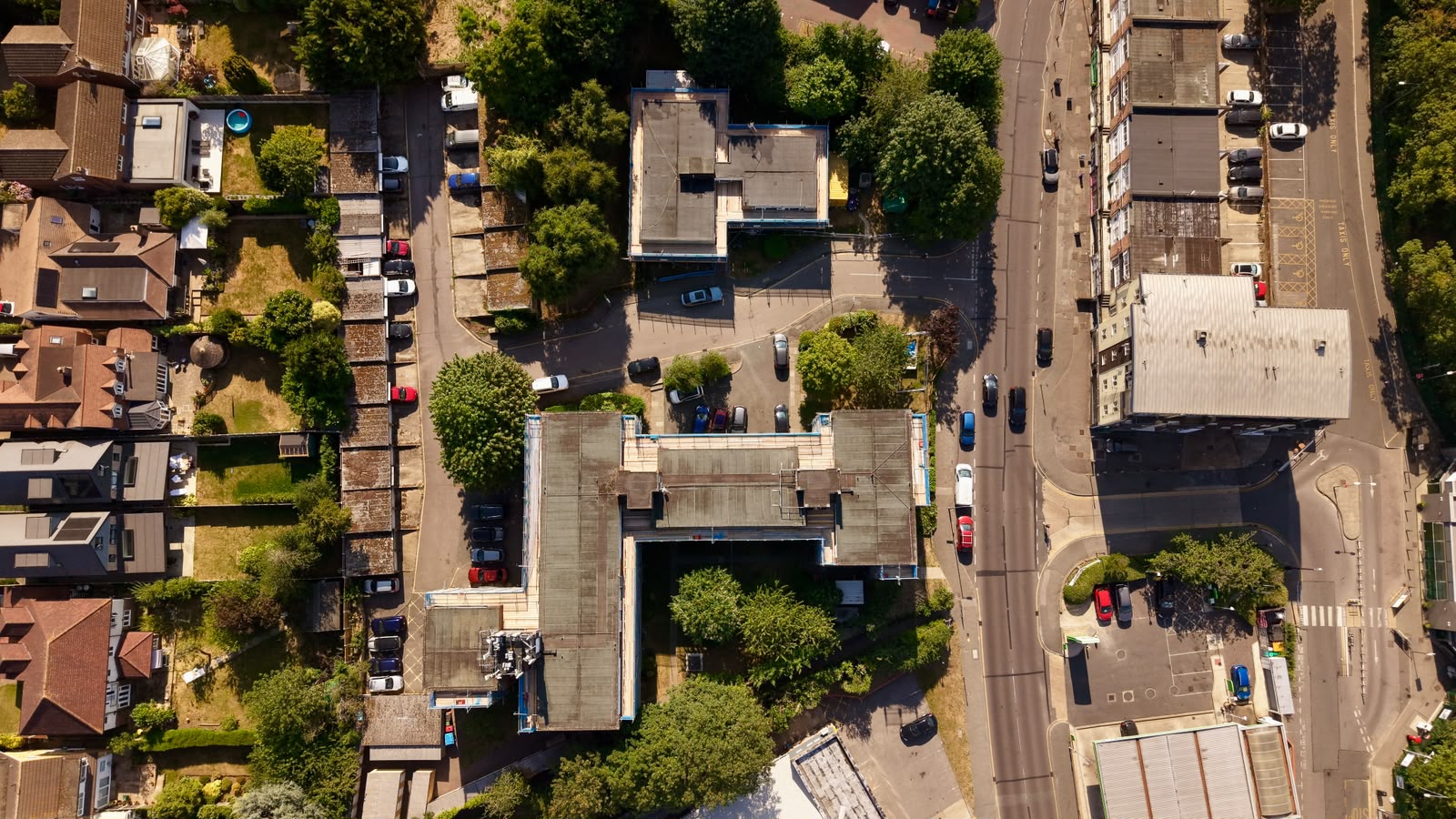 Top-down aerial view of scaffolding around a courtyard apartment development