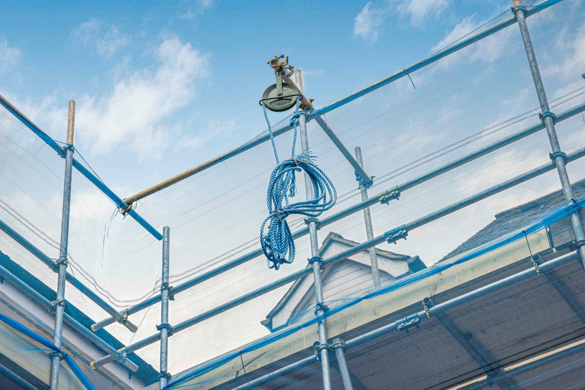 Residential scaffold with rope-and-pulley equipment for material lifting