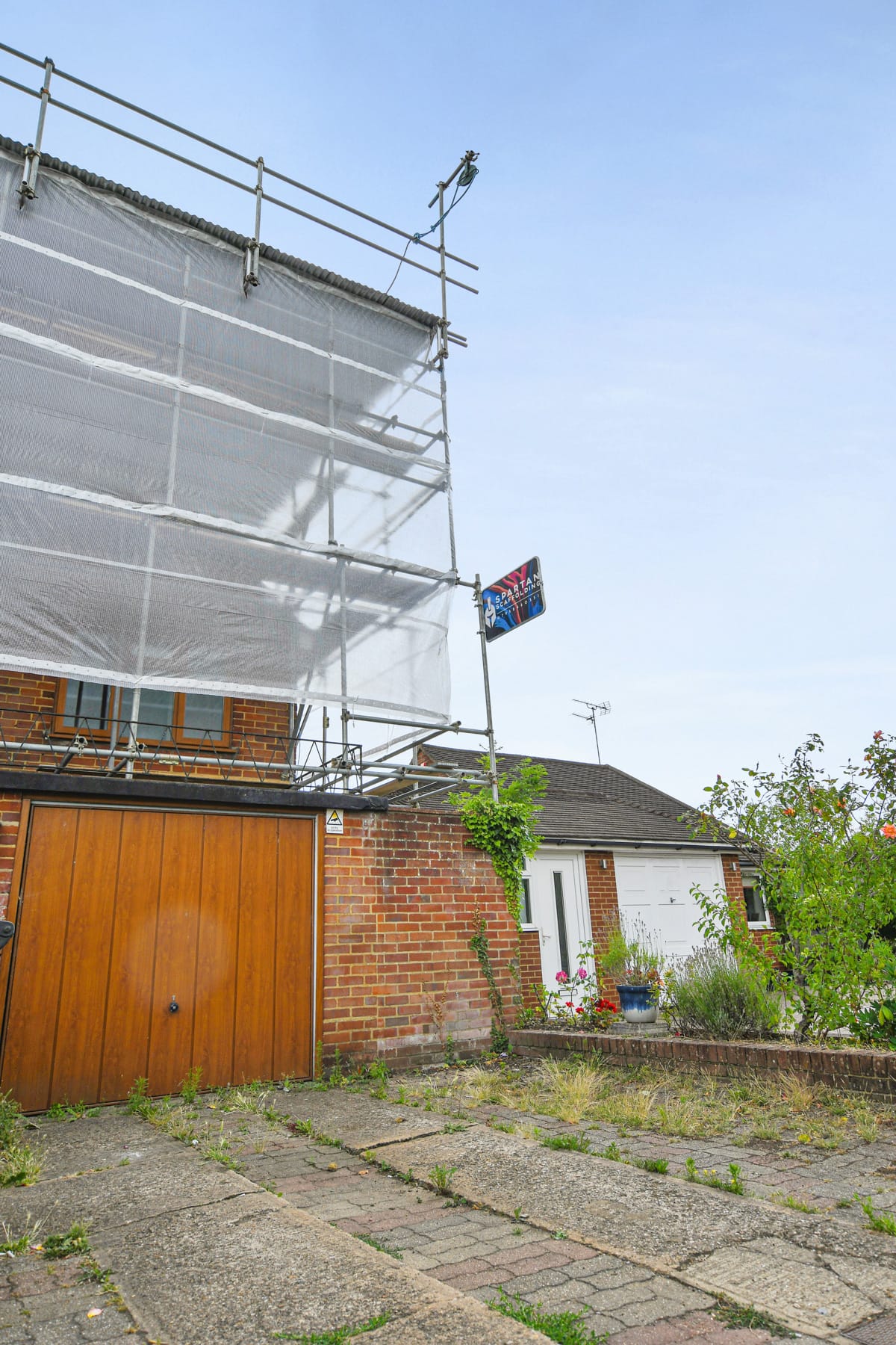 Scaffold with sheeting wrap protecting a house during works