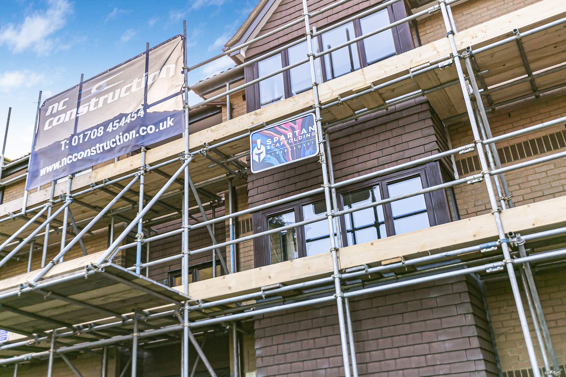 Residential scaffold on a brick house exterior