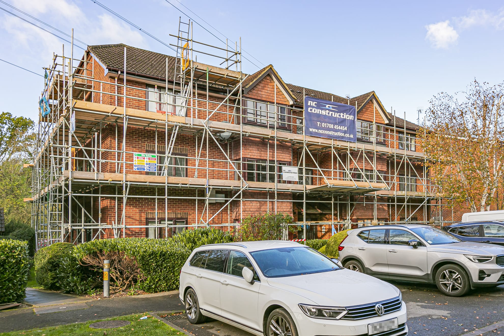 Scaffolding around a large brick townhouse