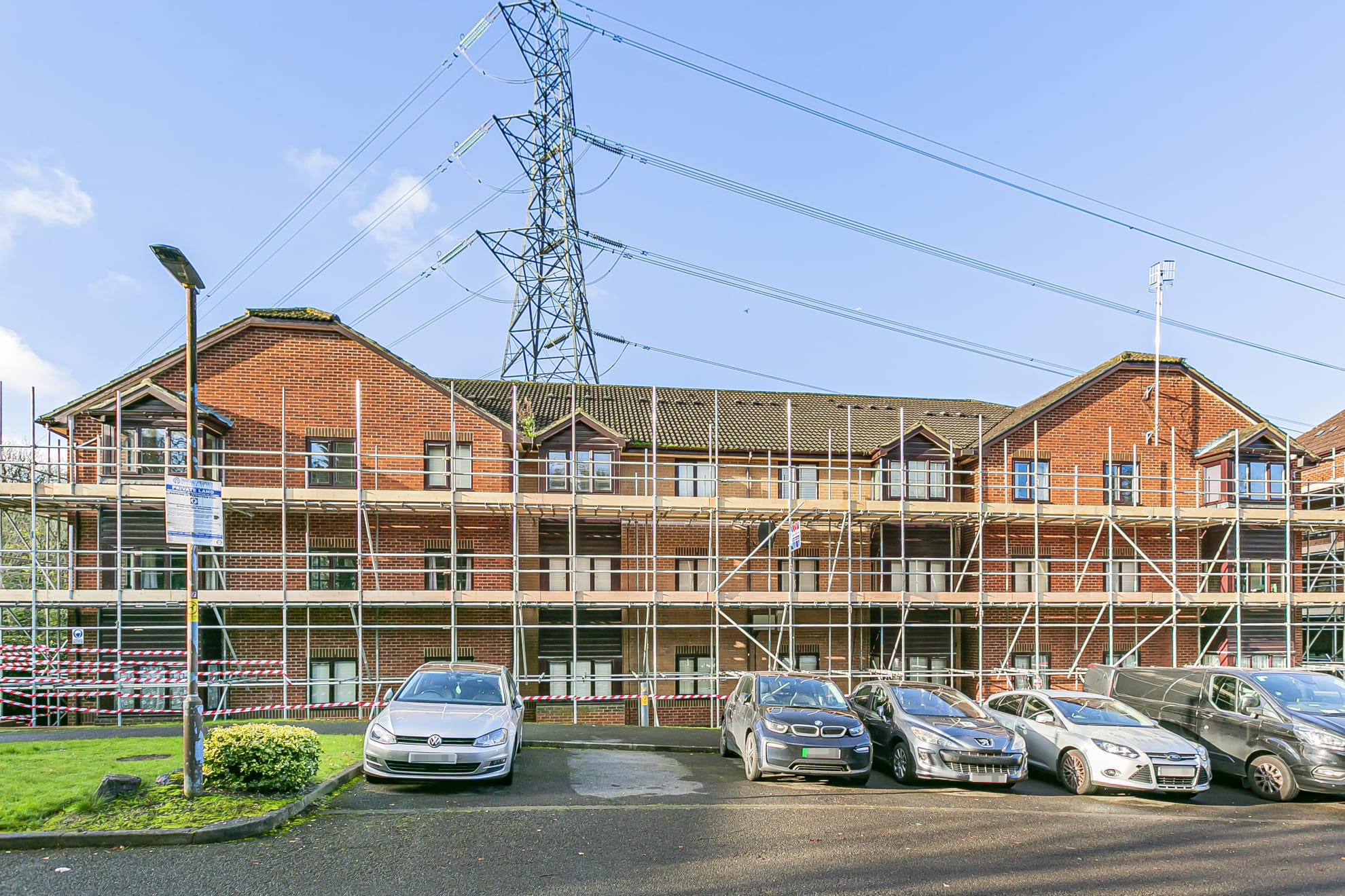 Large apartment building wrapped in scaffolding