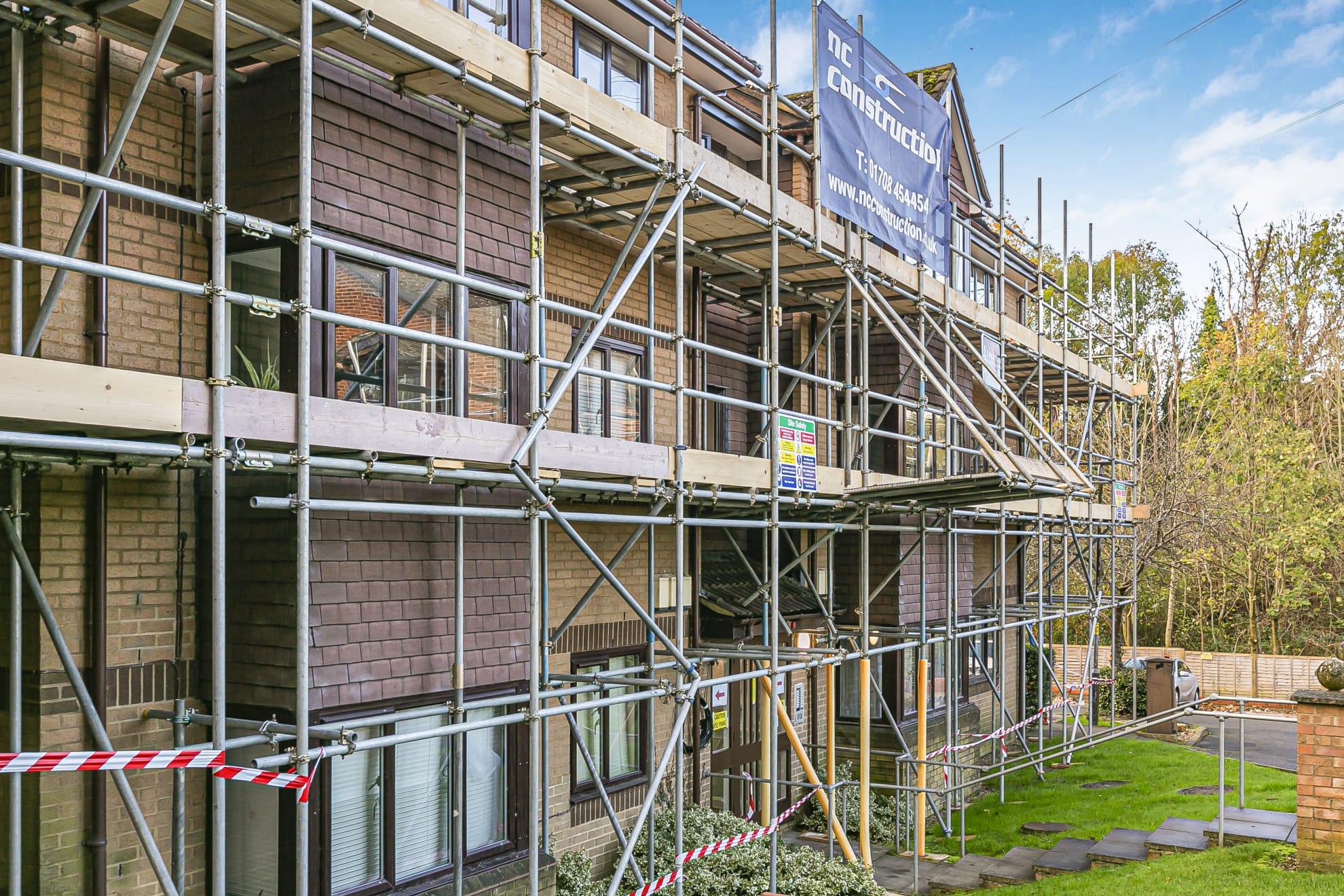Scaffolding around a three-storey residential building